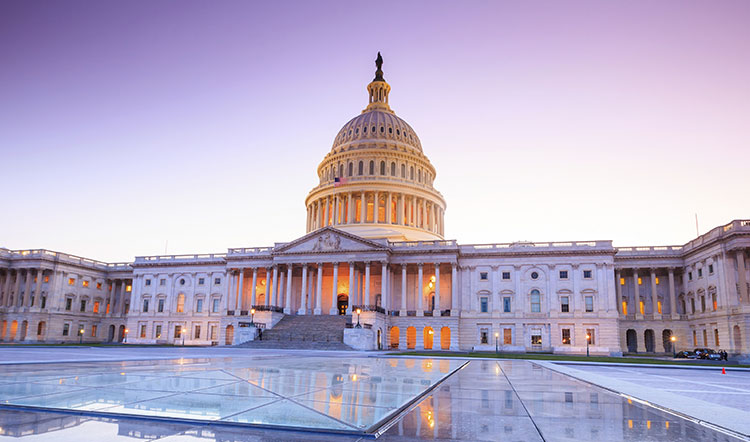 The United States Capitol building with its iconic dome and columns at sunset