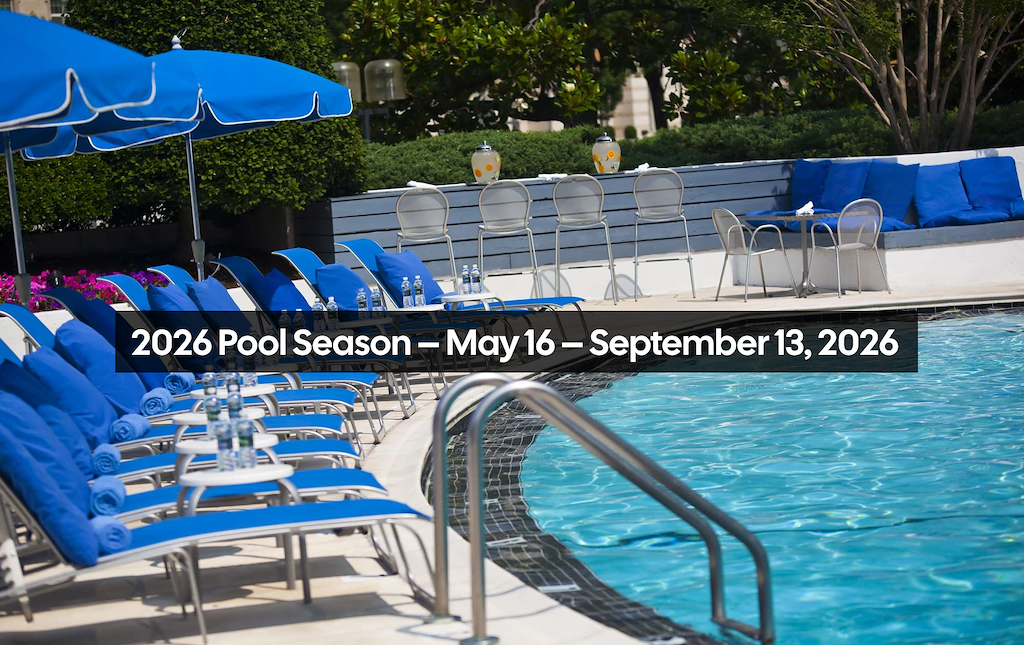 A pool with blue lounge chairs and umbrellas