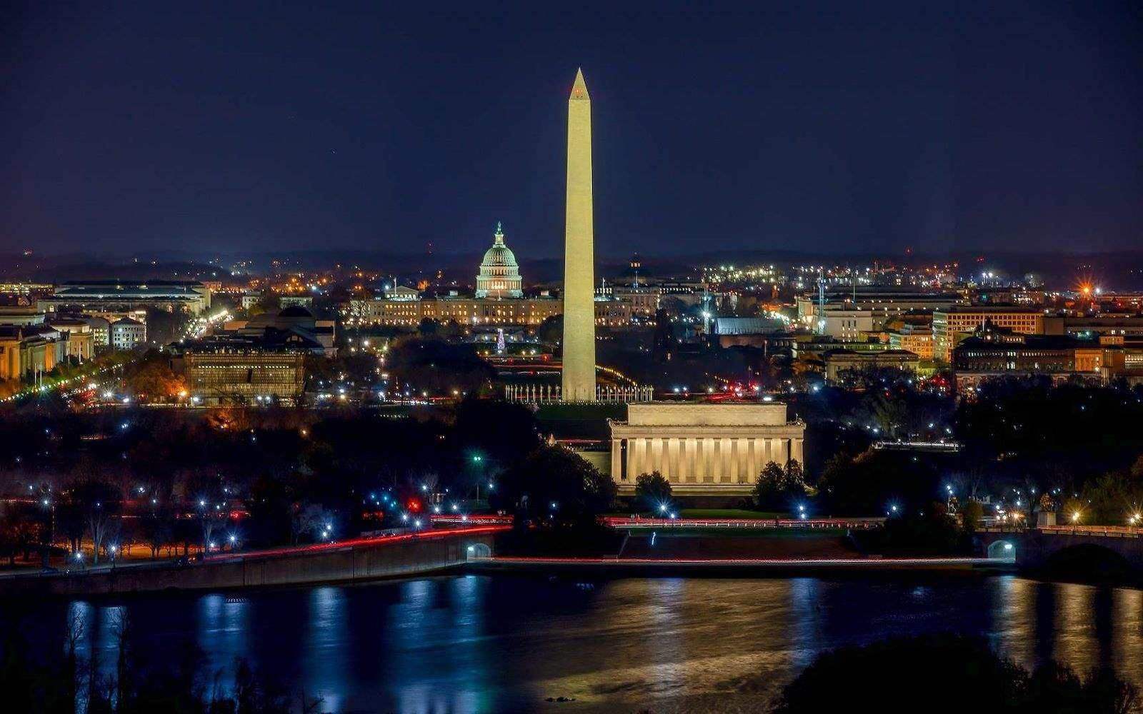a nighttime view of the Washington Monument, Lincoln Memorial, and Capitol Building in Washington D.C.